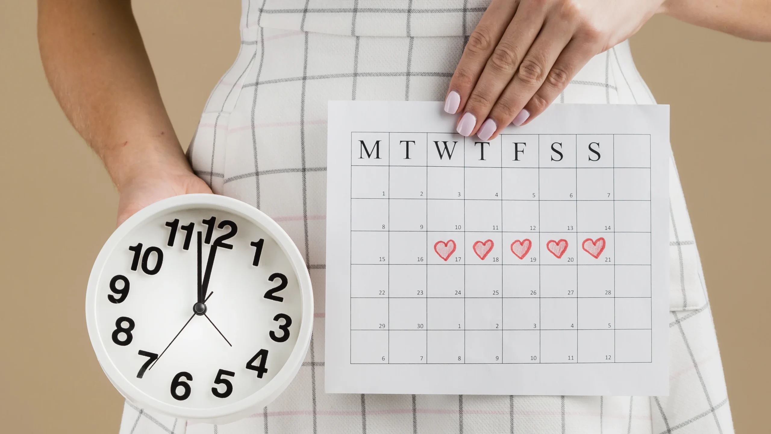 A woman holding a calendar marked with period dates and a clock, illustrating the timing of menstruation and addressing the question, can you get pregnant on your period