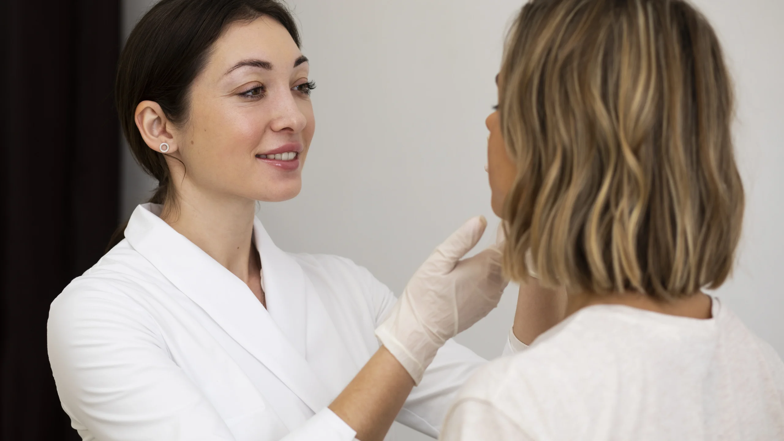 A healthcare professional examining a patient's face, emphasizing the importance of understanding what causes acne and seeking expert advice for diagnosis and treatment